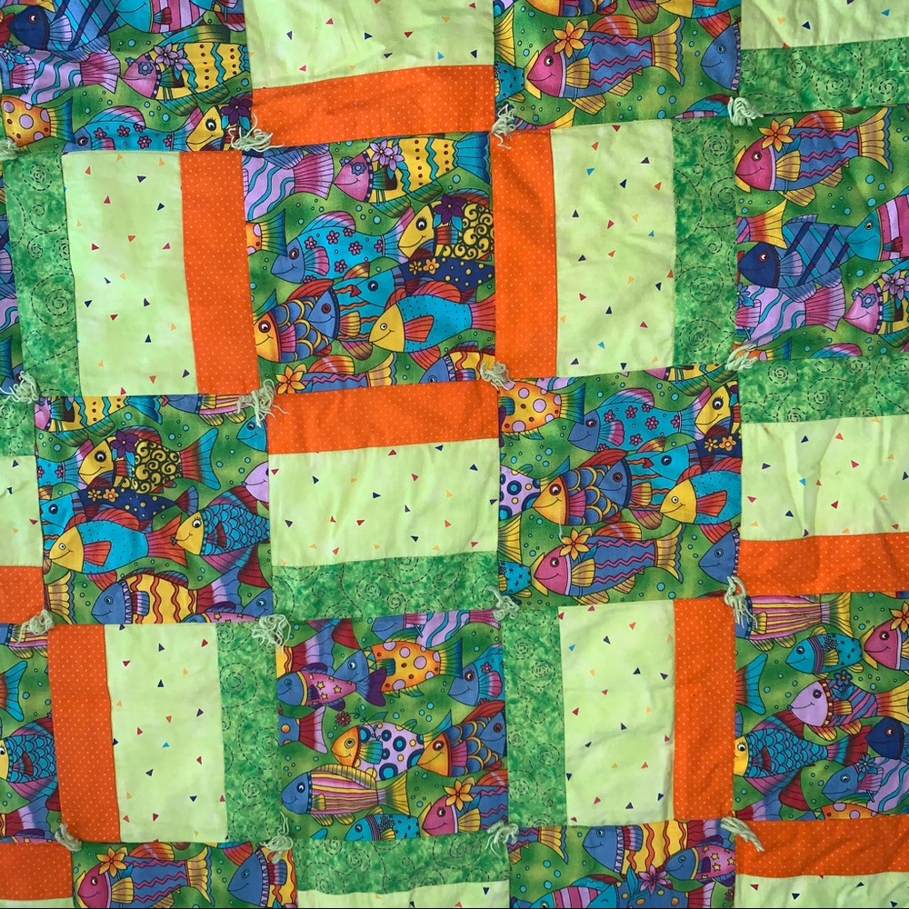 The rainbow fish inspired baby quilt 
Hand made